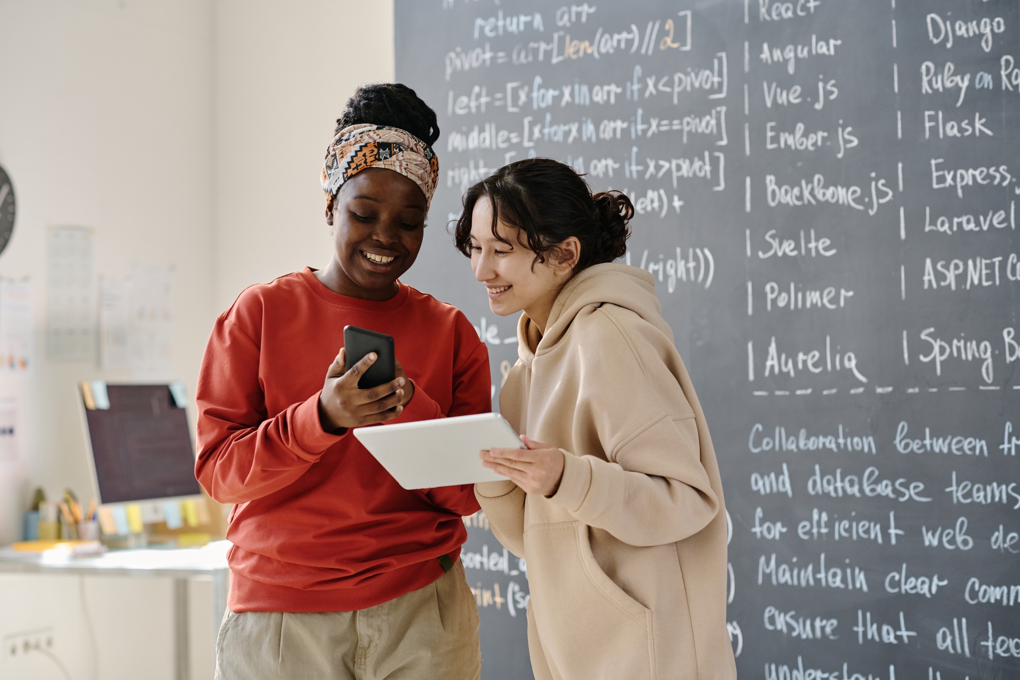 IT teacher discussing computer program with student