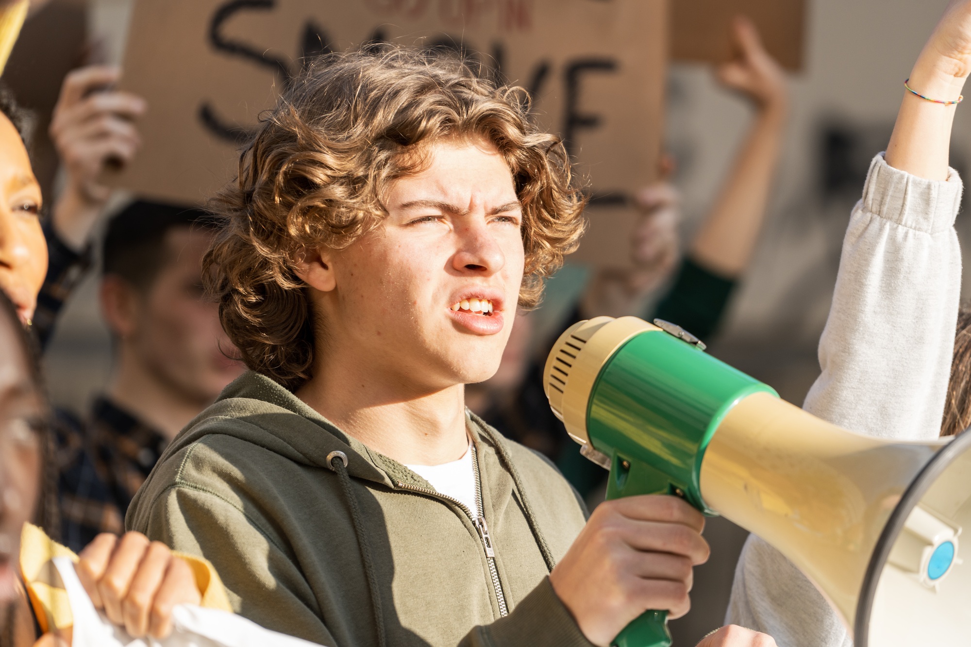 Passionate young activist with megaphone leads protest: youth voice for social change